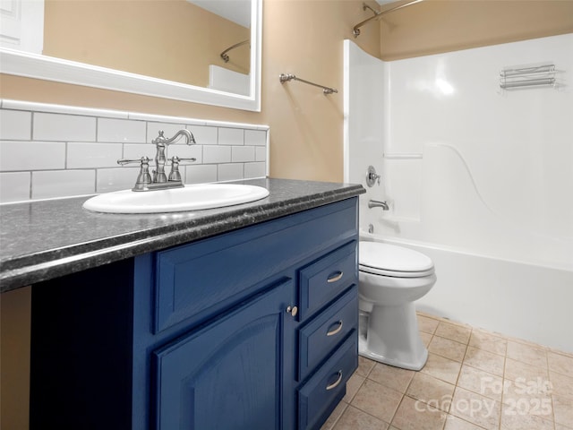 bathroom with tub / shower combination, vanity, tile patterned floors, toilet, and backsplash