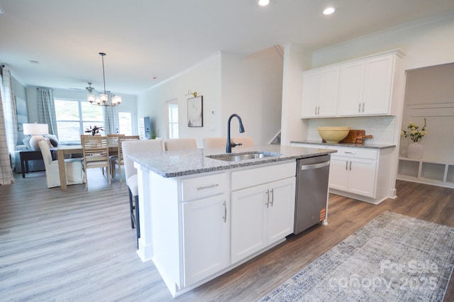 106 Sugg Trl, Weaverville, NC 28787 - kitchen with stainless steel dishwasher, light stone countertops, a kitchen island with sink, light wood-type flooring, and recessed lighting