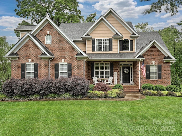 3409 Valdosta Ct, Monroe, NC 28110 - traditional-style house featuring covered porch, a front lawn, brick siding, and a shingled roof