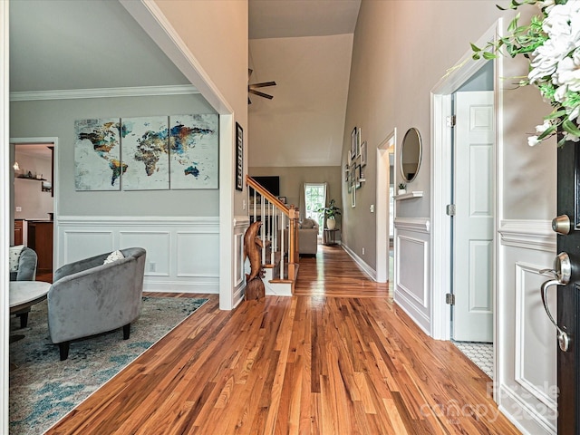 3409 Valdosta Ct, Monroe, NC 28110 - entrance foyer with stairway, wood finished floors, a wainscoted wall, crown molding, and high vaulted ceiling