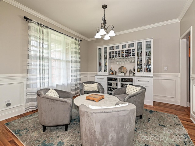 3409 Valdosta Ct, Monroe, NC 28110 - living area featuring wood finished floors, crown molding, a chandelier, wainscoting, and a bar