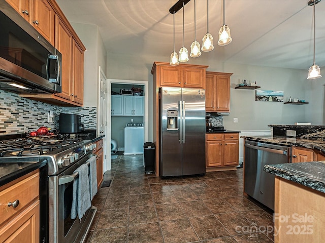 3409 Valdosta Ct, Monroe, NC 28110 - kitchen with stainless steel appliances, washer / dryer, brown cabinetry, and backsplash