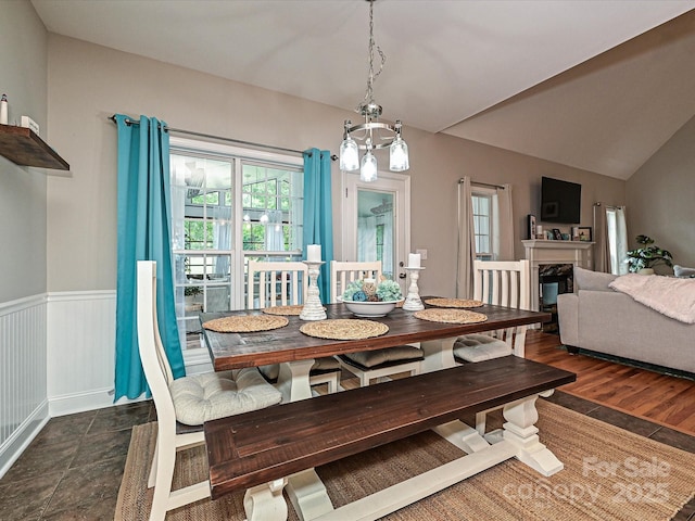 3409 Valdosta Ct, Monroe, NC 28110 - dining area with a wainscoted wall, lofted ceiling, a fireplace, and a chandelier