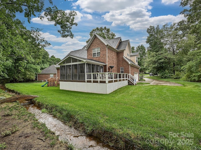 3409 Valdosta Ct, Monroe, NC 28110 - back of house featuring a sunroom, brick siding, a lawn, concrete driveway, and a garage