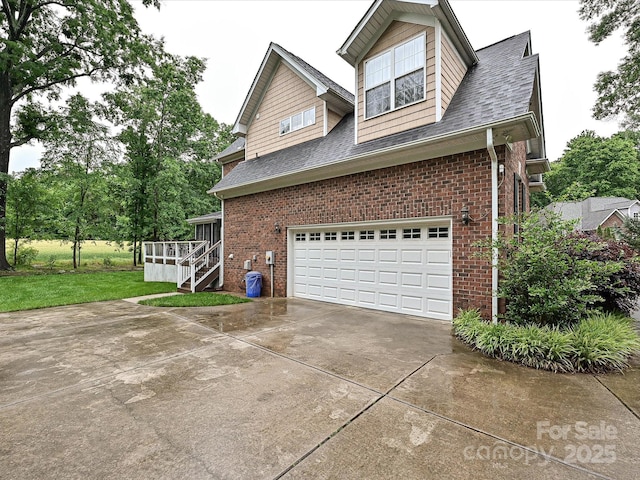 3409 Valdosta Ct, Monroe, NC 28110 - view of home's exterior with driveway, an attached garage, brick siding, stairway, and a shingled roof