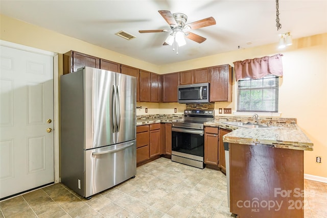 7206 Stoney Place Ct, Charlotte, NC 28262 - kitchen with appliances with stainless steel finishes, a sink, a peninsula, ceiling fan, and light countertops