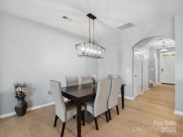 3306 Yarmouth Ln, Gastonia, NC 28056 - dining space with a chandelier, light wood-style flooring, and arched walkways