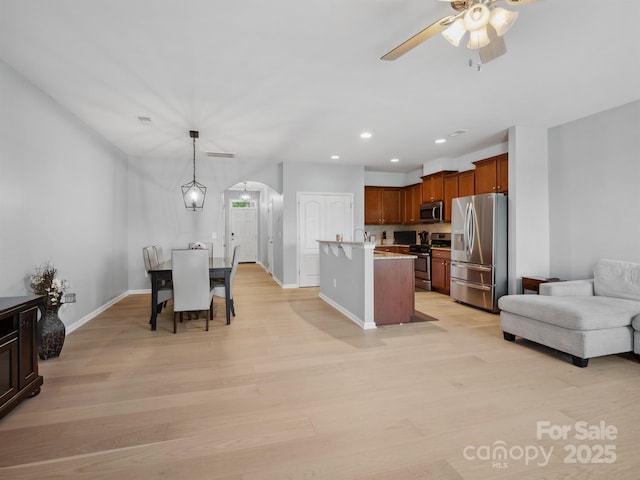 3306 Yarmouth Ln, Gastonia, NC 28056 - dining room featuring arched walkways, light wood-style floors, ceiling fan, and recessed lighting
