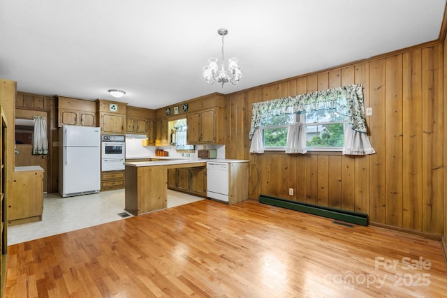 713 Crozet St NW, Valdese, NC 28690 - kitchen featuring white appliances, a baseboard radiator, a chandelier, brown cabinets, and light wood-style flooring