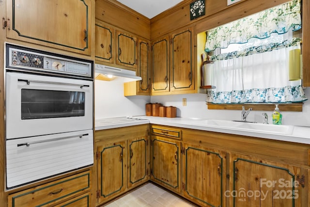 713 Crozet St NW, Valdese, NC 28690 - kitchen with white appliances, a warming drawer, under cabinet range hood, and brown cabinetry