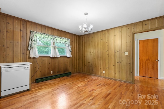 713 Crozet St NW, Valdese, NC 28690 - unfurnished dining area featuring a baseboard radiator, a chandelier, light wood-type flooring, and wooden walls