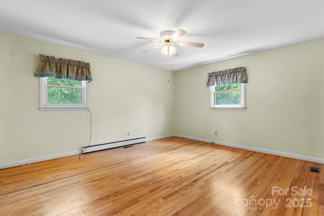 713 Crozet St NW, Valdese, NC 28690 - empty room featuring baseboard heating, wood finished floors, a ceiling fan, and baseboards