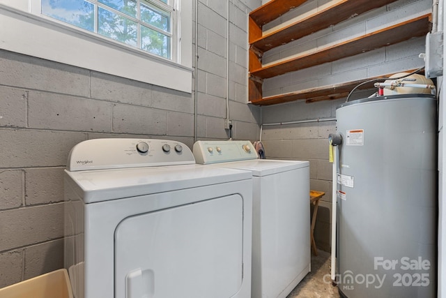 713 Crozet St NW, Valdese, NC 28690 - laundry area featuring electric water heater, washing machine and dryer, and concrete block wall