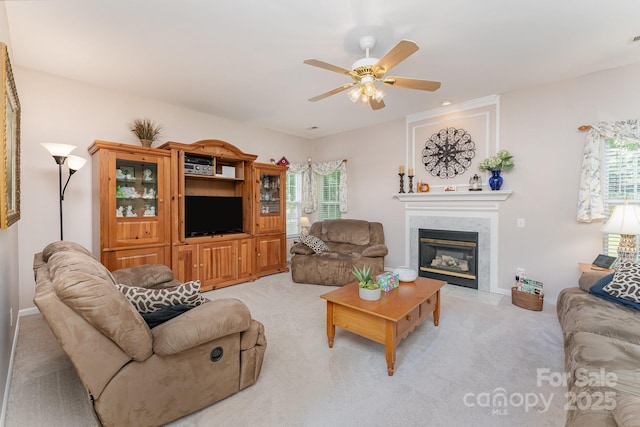 10322 Stoneykirk Ln, Charlotte, NC 28269 - living room featuring light carpet, a ceiling fan, a high end fireplace, and healthy amount of natural light