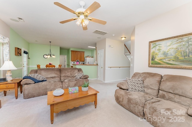 10322 Stoneykirk Ln, Charlotte, NC 28269 - living area with light colored carpet, stairs, a ceiling fan, baseboards, and a chandelier