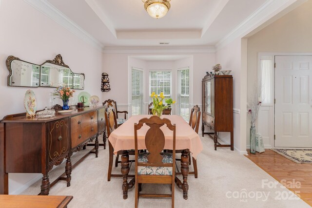 10322 Stoneykirk Ln, Charlotte, NC 28269 - dining space with a tray ceiling and ornamental molding