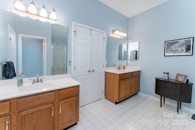 10322 Stoneykirk Ln, Charlotte, NC 28269 - full bathroom with a stall shower, two vanities, and baseboards