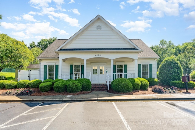 10322 Stoneykirk Ln, Charlotte, NC 28269 - view of front of house featuring uncovered parking, covered porch, a gate, and roof with shingles