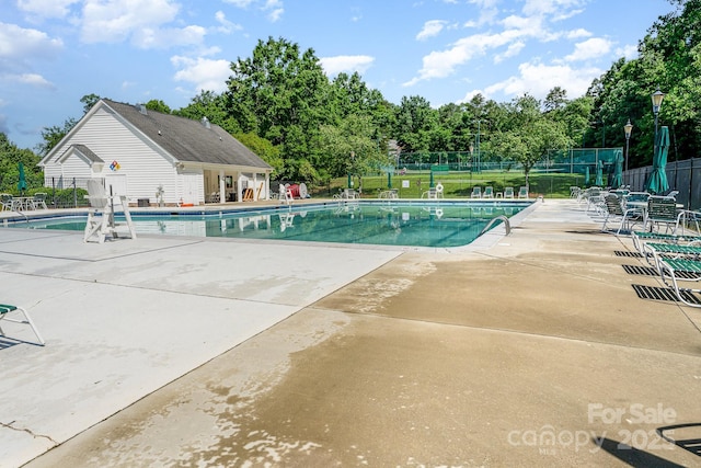 10322 Stoneykirk Ln, Charlotte, NC 28269 - community pool featuring fence, a patio, and view of wooded area