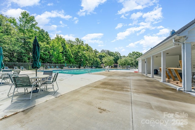 10322 Stoneykirk Ln, Charlotte, NC 28269 - community pool with fence, a patio, and view of wooded area