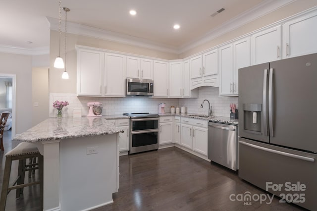 148 Adelaide Way, Rock Hill, SC 29732 - kitchen featuring appliances with stainless steel finishes, a peninsula, a sink, ornamental molding, and white cabinets