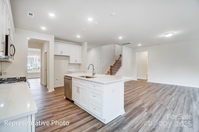 2233 Tabor Rd Unit 586, Sherrills Ford, NC 28673 - kitchen with a sink, appliances with stainless steel finishes, light wood-type flooring, a kitchen island with sink, and baseboards