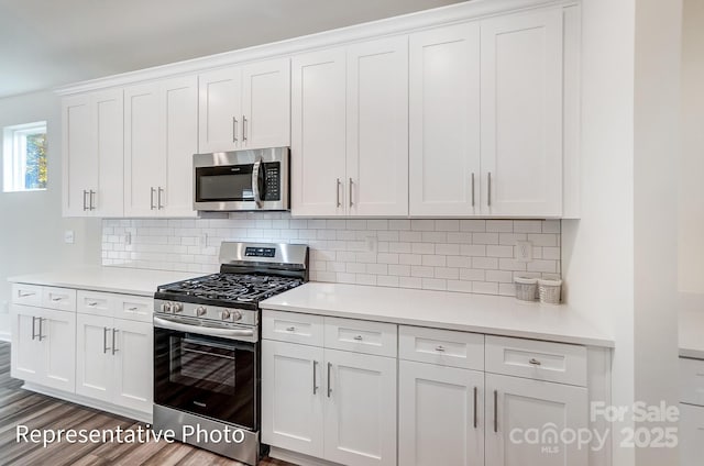 2233 Tabor Rd Unit 586, Sherrills Ford, NC 28673 - kitchen with appliances with stainless steel finishes, light countertops, white cabinetry, and backsplash