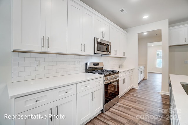 2233 Tabor Rd Unit 586, Sherrills Ford, NC 28673 - kitchen featuring stainless steel appliances, light wood finished floors, white cabinetry, light countertops, and recessed lighting