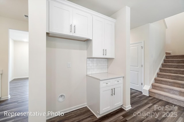 2233 Tabor Rd Unit 586, Sherrills Ford, NC 28673 - kitchen with dark wood-style floors, white cabinets, light countertops, tasteful backsplash, and baseboards