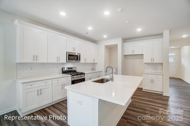 2233 Tabor Rd Unit 586, Sherrills Ford, NC 28673 - kitchen with appliances with stainless steel finishes, a sink, dark wood-style floors, a center island with sink, and recessed lighting