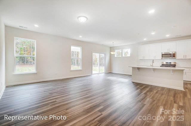 2233 Tabor Rd Unit 586, Sherrills Ford, NC 28673 - unfurnished living room featuring wood finished floors, recessed lighting, baseboards, and a sink