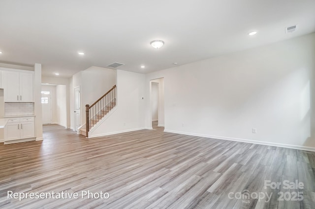 2233 Tabor Rd Unit 586, Sherrills Ford, NC 28673 - unfurnished living room with light wood-style floors, stairs, baseboards, and recessed lighting