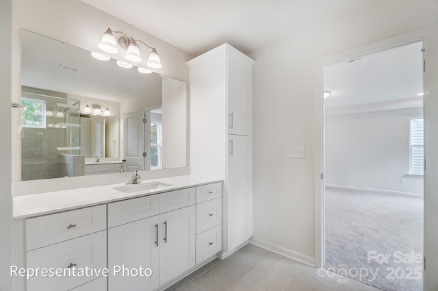 2233 Tabor Rd Unit 586, Sherrills Ford, NC 28673 - bathroom featuring a tile shower, healthy amount of natural light, vanity, and baseboards