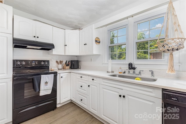 875 Marys Grove Rd, Cherryville, NC 28021 - kitchen featuring under cabinet range hood, black appliances, a sink, and white cabinetry
