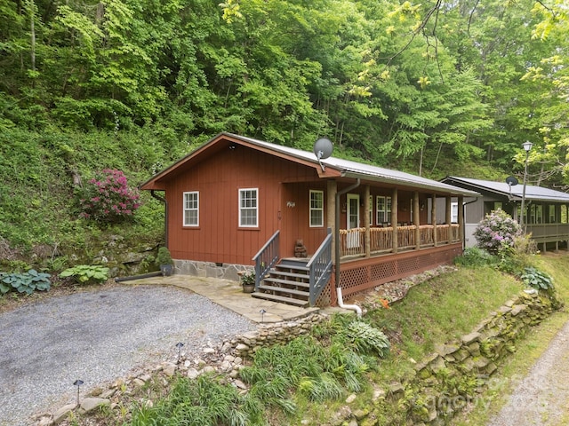 79 Jeffrey Ln, Waynesville, NC 28785 - view of front of property featuring covered porch, crawl space, and a forest view