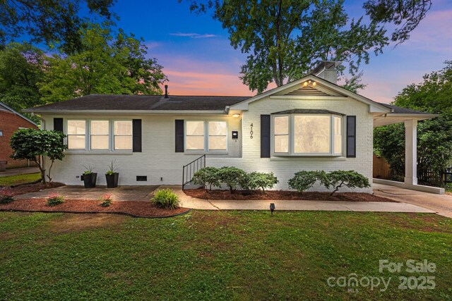 4106 Castlewood Rd, Charlotte, NC 28209 - single story home featuring a front yard, brick siding, a chimney, and a carport