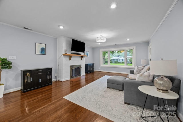 4106 Castlewood Rd, Charlotte, NC 28209 - living room with crown molding, dark wood-style flooring, baseboards, a brick fireplace, and recessed lighting