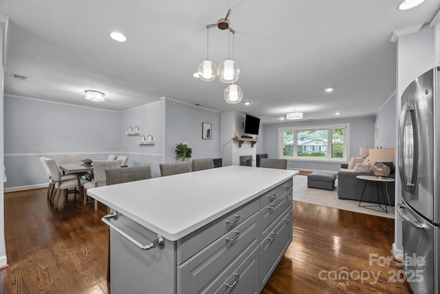 4106 Castlewood Rd, Charlotte, NC 28209 - kitchen featuring freestanding refrigerator, gray cabinets, open floor plan, crown molding, and a brick fireplace