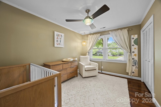 4106 Castlewood Rd, Charlotte, NC 28209 - bedroom with ornamental molding, wood finished floors, baseboards, ceiling fan, and a crib