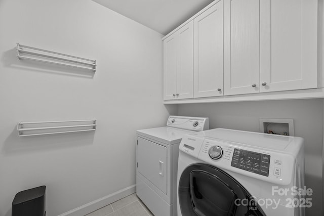 4106 Castlewood Rd, Charlotte, NC 28209 - laundry area featuring cabinet space, washing machine and dryer, baseboards, and light tile patterned flooring