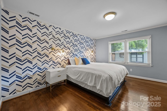 4106 Castlewood Rd, Charlotte, NC 28209 - bedroom featuring an accent wall, wallpapered walls, baseboards, dark wood-type flooring, and ornamental molding