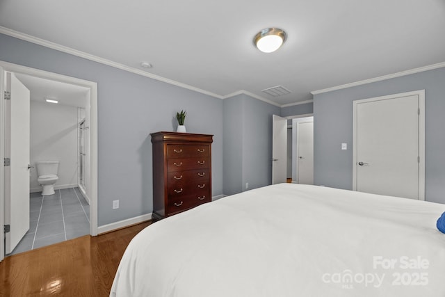 4106 Castlewood Rd, Charlotte, NC 28209 - bedroom featuring crown molding, wood finished floors, baseboards, and connected bathroom