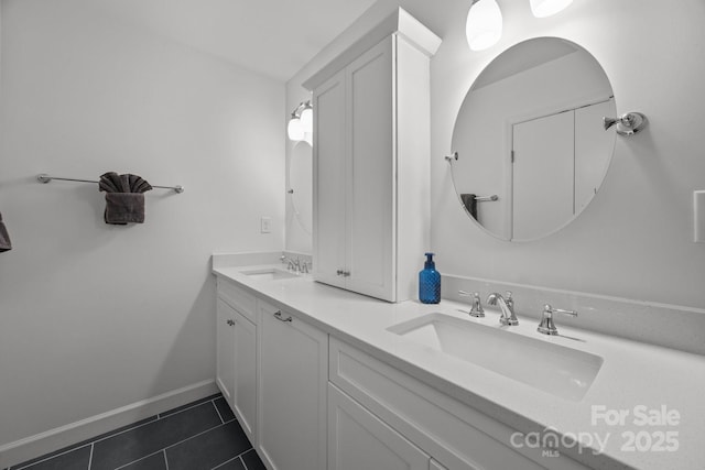 4106 Castlewood Rd, Charlotte, NC 28209 - bathroom featuring double vanity, tile patterned flooring, and baseboards