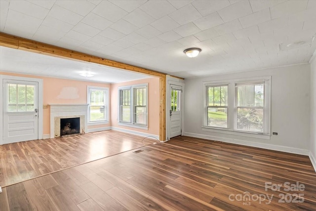 24515 Saint Martin Rd, Albemarle, NC 28001 - unfurnished living room featuring a fireplace, wood finished floors, and baseboards