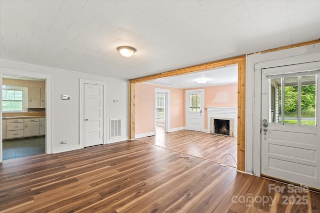 24515 Saint Martin Rd, Albemarle, NC 28001 - unfurnished living room with a fireplace, wood finished floors, and baseboards