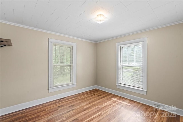 24515 Saint Martin Rd, Albemarle, NC 28001 - unfurnished room with healthy amount of natural light, baseboards, wood finished floors, and crown molding
