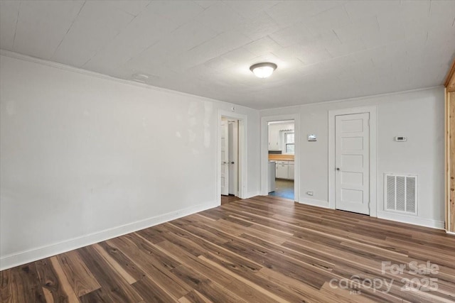24515 Saint Martin Rd, Albemarle, NC 28001 - spare room with dark wood-style floors, baseboards, and crown molding