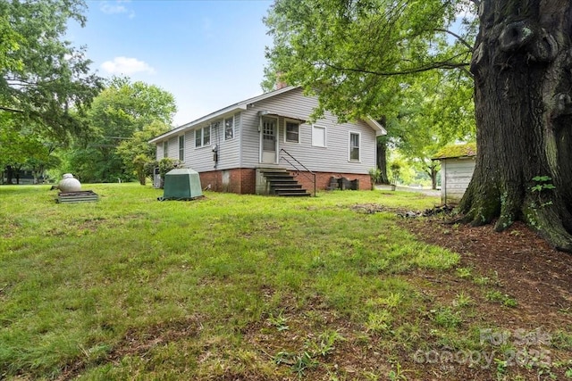 24515 Saint Martin Rd, Albemarle, NC 28001 - back of property with a lawn and entry steps