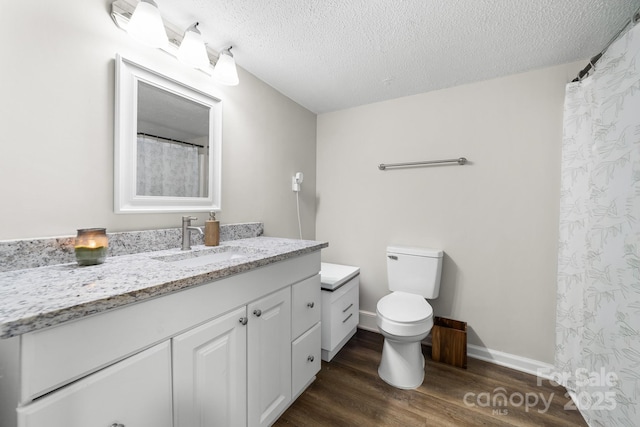 3716 Hamilton Dr, Gastonia, NC 28052 - full bathroom featuring wood finished floors, vanity, toilet, and a textured ceiling