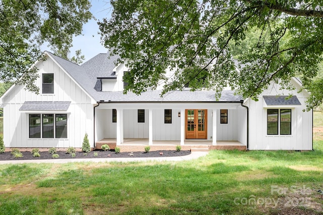 104 Arbor Dr, Waxhaw, NC 28173 - modern inspired farmhouse with board and batten siding, a porch, a shingled roof, and a front yard